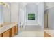 Primary bath featuring double sinks, a tub, and separate shower at 4001 English Valley Dr, Ellenwood, GA 30294
