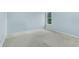 This bedroom has light blue walls, carpet, and a window at 4001 English Valley Dr, Ellenwood, GA 30294