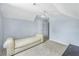 Bedroom with plush carpeting, complemented by a stylish couch and natural light at 4001 English Valley Dr, Ellenwood, GA 30294