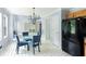 Eat-in kitchen dining area with modern glass table, upholstered chairs and black appliances at 4001 English Valley Dr, Ellenwood, GA 30294