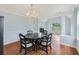 Elegant dining room featuring hardwood floors, a chandelier, and classic decor at 4001 English Valley Dr, Ellenwood, GA 30294