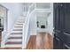Bright foyer featuring hardwood floors, stairs leading to the second level, and views to the living room at 4001 English Valley Dr, Ellenwood, GA 30294