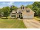 Charming two-story home with a well-maintained lawn, two car garage and mature landscaping at 4001 English Valley Dr, Ellenwood, GA 30294