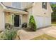 Inviting front porch with seating, a landscaped yard and an attached two-car garage at 4001 English Valley Dr, Ellenwood, GA 30294