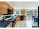 Well-lit kitchen with updated appliances, wood cabinets, and a view to the dining area at 4001 English Valley Dr, Ellenwood, GA 30294