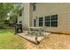 Back patio with outdoor table and chairs, perfect for enjoying outdoor living at 4001 English Valley Dr, Ellenwood, GA 30294