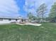 Spacious backyard with a patio, outdoor kitchen, fire pit, and lush green grass at 464 Mason Dr, Canton, GA 30115