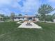 Scenic backyard featuring a fire pit, covered deck with grill, and lush greenery at 464 Mason Dr, Canton, GA 30115