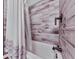 Close-up of a shower-tub combo featuring wood-look tiling and a modern showerhead for a stylish bathroom upgrade at 464 Mason Dr, Canton, GA 30115