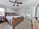 A cozy bedroom featuring a rustic wooden bed frame, soft carpet, and neutral tones for a relaxing atmosphere at 464 Mason Dr, Canton, GA 30115
