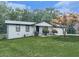 Charming one-story home features a white brick exterior, manicured lawn and mature trees at 464 Mason Dr, Canton, GA 30115