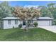 Charming single-story home featuring a well-manicured lawn and a tree-lined yard, offering a serene outdoor space at 464 Mason Dr, Canton, GA 30115