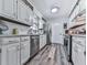 Bright kitchen featuring white cabinets, stainless steel appliances, and hardwood flooring at 464 Mason Dr, Canton, GA 30115