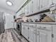 Bright kitchen featuring white cabinets, stainless steel appliances, and hardwood flooring at 464 Mason Dr, Canton, GA 30115