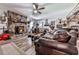 Inviting living room features hardwood floors, stone fireplace, ceiling fan and unique decor at 464 Mason Dr, Canton, GA 30115