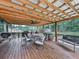 Spacious covered patio with a dining table and chairs, ceiling fan, and outdoor cooking equipment, perfect for entertaining at 464 Mason Dr, Canton, GA 30115