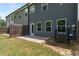 Townhome backyard featuring a small patio and privacy fence at 5095 Lower Elm St, Atlanta, GA 30349