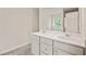 This bathroom features a dual sink vanity combination with a mirror and neutral colors at 5095 Lower Elm St, Atlanta, GA 30349