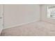 Bright bedroom with a window for natural light and neutral carpeting at 5095 Lower Elm St, Atlanta, GA 30349