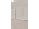Bedroom with neutral walls and carpeting and two paneled doors leading to other areas at 5095 Lower Elm St, Atlanta, GA 30349