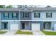 These charming townhomes come with attached garages and pleasing light blue and grey color schemes at 5095 Lower Elm St, Atlanta, GA 30349