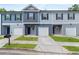 Charming townhomes with attached garages, well-kept lawns, and coordinated neutral color schemes at 5095 Lower Elm St, Atlanta, GA 30349