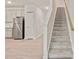 Carpeted staircase that offers access to the second story is conveniently located near the modern kitchen at 5095 Lower Elm St, Atlanta, GA 30349