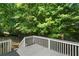 Inviting gray back deck surrounded by nature, offering a serene outdoor living space at 545 Willow Creek Dr, Temple, GA 30179