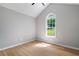Bedroom featuring a vaulted ceiling and a large window at 545 Willow Creek Dr, Temple, GA 30179