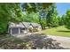 View of home featuring long driveway leading up to a white-sided ranch home with an attached two-car garage at 545 Willow Creek Dr, Temple, GA 30179