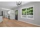 Bright kitchen features white cabinets, modern lighting, stainless appliances, and wood flooring at 545 Willow Creek Dr, Temple, GA 30179