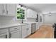 Stylish kitchen featuring white cabinets, solid countertops, wood-look flooring and stainless steel appliances at 545 Willow Creek Dr, Temple, GA 30179