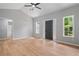 Large living room with wood floors, tall ceilings, neutral paint and lots of natural light from big windows at 545 Willow Creek Dr, Temple, GA 30179