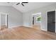 Bright open concept living space with vaulted ceilings, wood floors, modern ceiling fan and neutral paint at 545 Willow Creek Dr, Temple, GA 30179