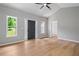 Open living room featuring wood floors, a ceiling fan, neutral paint, and lots of natural light at 545 Willow Creek Dr, Temple, GA 30179