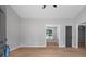 Open-concept living space with wood flooring, neutral paint, high ceilings, and great natural light at 545 Willow Creek Dr, Temple, GA 30179