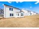 New construction backyard with white siding, a sunroom, and ample space for outdoor activities at 1619 Tide Mill Road, Cumming, GA 30040