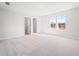 A serene bedroom with neutral tones, bright windows, and an open closet, perfect for relaxation at 1619 Tide Mill Road, Cumming, GA 30040