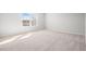 Spacious bedroom with plush carpeting and bright windows, providing natural light at 1619 Tide Mill Road, Cumming, GA 30040