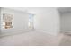Comfortable bedroom featuring neutral carpet, natural light, and ample space, perfect for relaxation at 1619 Tide Mill Road, Cumming, GA 30040