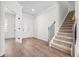 Bright entryway featuring wood floors, staircase with black railings, and glass doors leading to another room at 1619 Tide Mill Road, Cumming, GA 30040