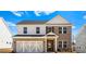 Charming two-story home with brick and siding, complemented by a two-car garage and well-manicured landscaping at 1619 Tide Mill Road, Cumming, GA 30040