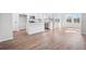 Modern kitchen featuring white cabinets, stainless steel appliances, and an island, flowing into the dining area at 1619 Tide Mill Road, Cumming, GA 30040