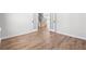 Open living space with wood-look floors, white trim, and a view into another room through glass doors at 1619 Tide Mill Road, Cumming, GA 30040