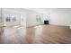 Spacious living area with wood flooring, bright natural light, and a cozy fireplace, perfect for gatherings at 1619 Tide Mill Road, Cumming, GA 30040