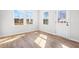 Bright sunroom with wood-look flooring, large windows, and a door to the backyard, creating a cozy space at 1619 Tide Mill Road, Cumming, GA 30040