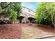 Exterior view of the rear of the home with private balconies, garden spaces, and mature trees at 1646 Sandy Beach Pt, Lawrenceville, GA 30043