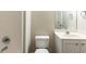 Neutral toned bathroom featuring a sink vanity, mirror and standard toilet at 1646 Sandy Beach Pt, Lawrenceville, GA 30043