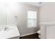 Bathroom featuring a tiled tub-shower and single sink vanity with dark wood floors at 1646 Sandy Beach Pt, Lawrenceville, GA 30043