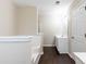 Bathroom featuring a tiled tub-shower and single sink vanity with dark wood floors at 1646 Sandy Beach Pt, Lawrenceville, GA 30043
